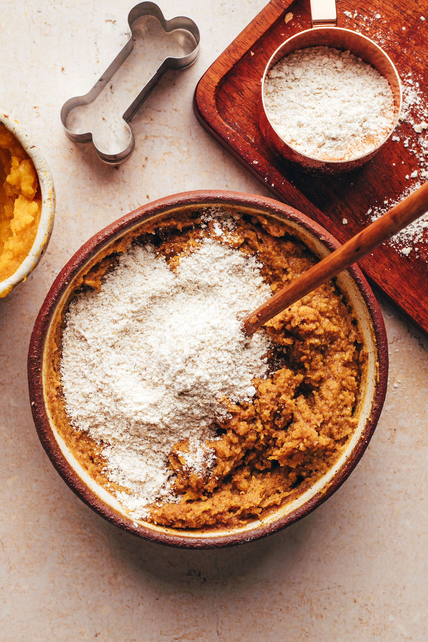 Stirring oat flour into a pumpkin peanut butter mixture