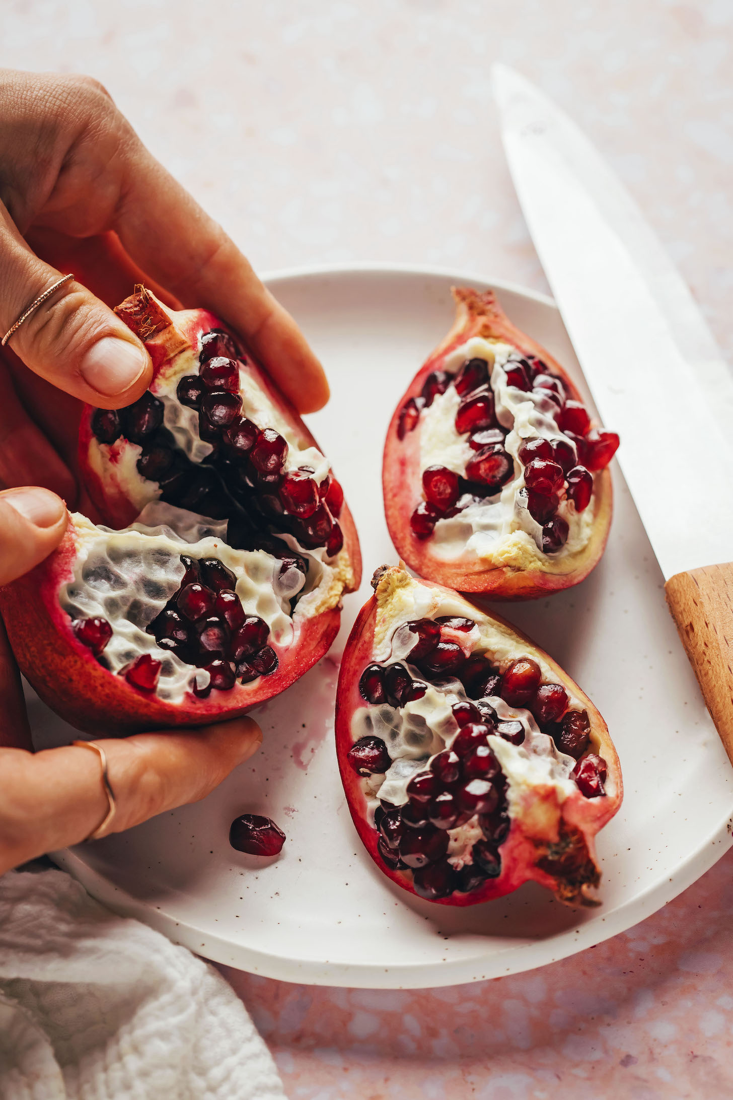 Breaking apart a pomegranate into four quarters