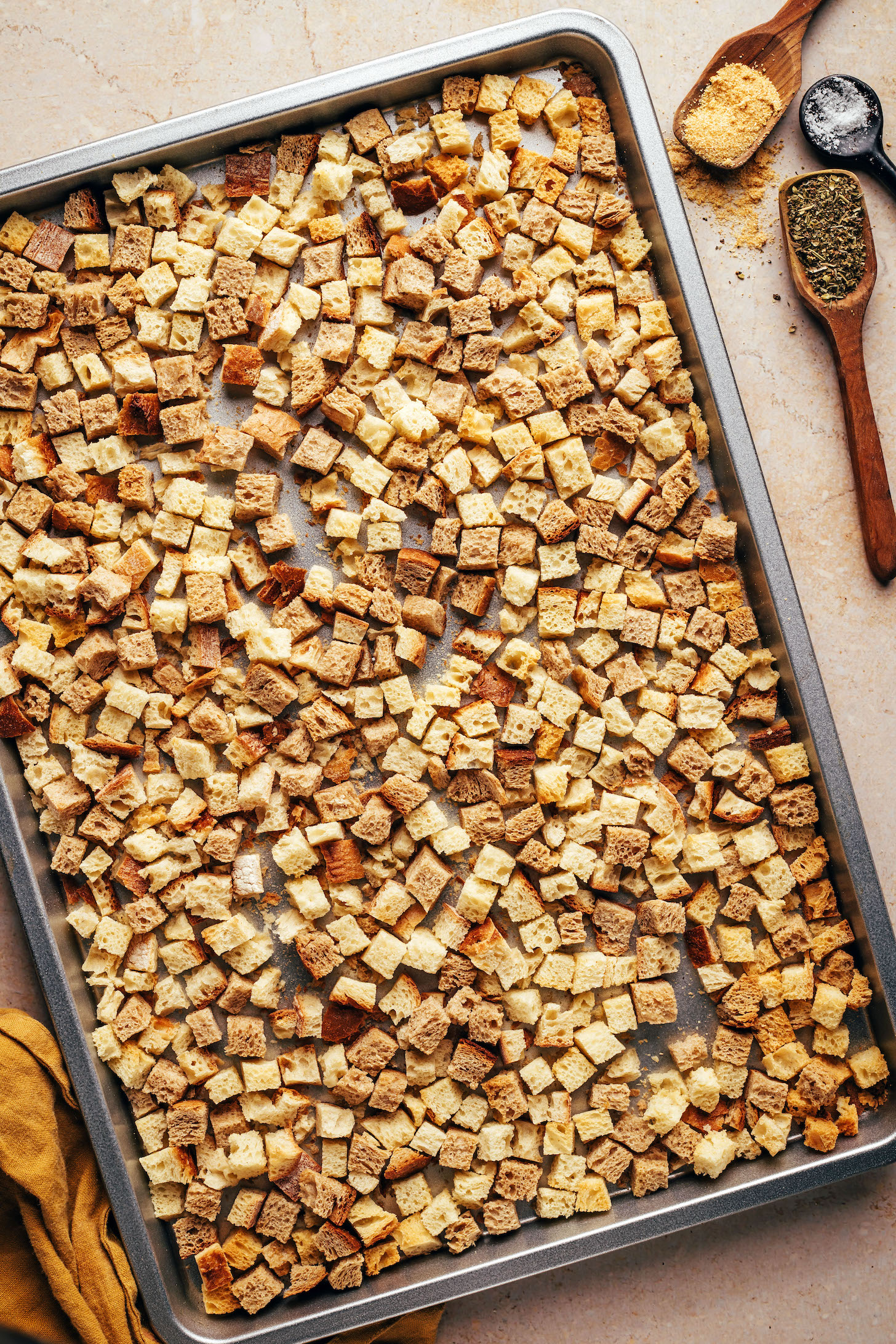 Cubed bread on a baking sheet