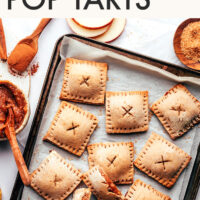 Mini apple butter pop tarts on a baking sheet