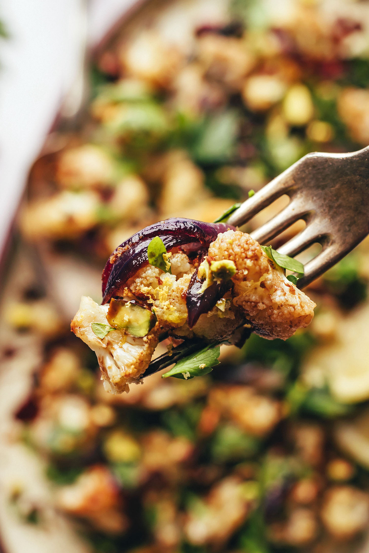 Bite of roasted cauliflower salad on a fork