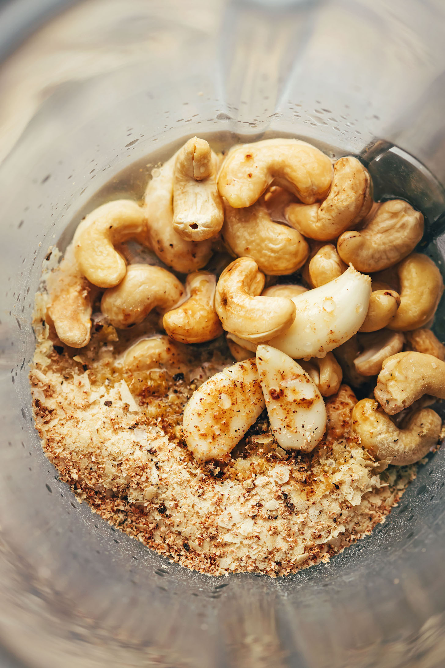 Cashews, garlic, water, and seasonings in a blender to make a dairy-free cream sauce