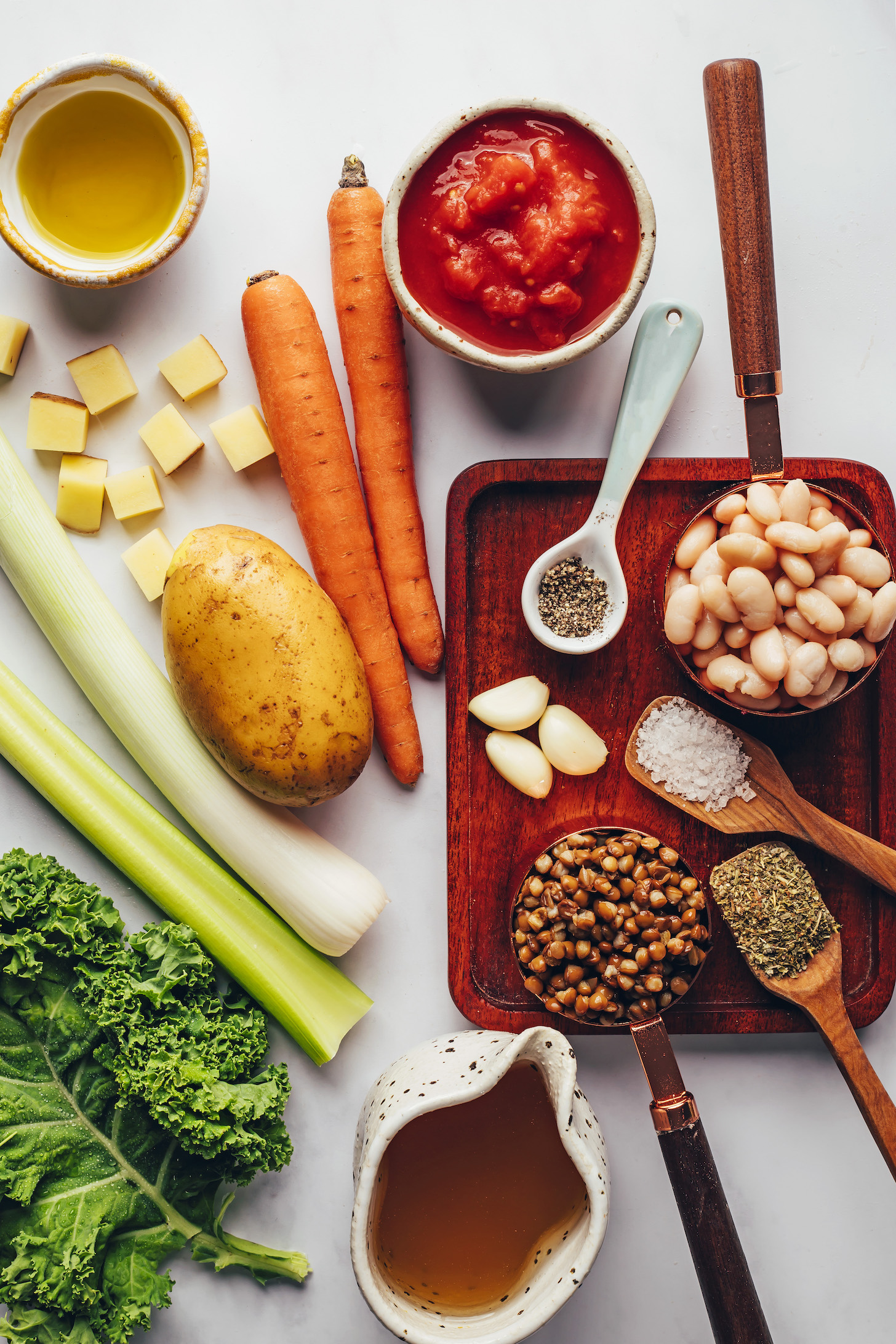 Kale, celery, potatoes, carrots, olive oil, diced tomatoes, white beans, salt, pepper, garlic, dried Italian herbs, lentils, and vegetable broth