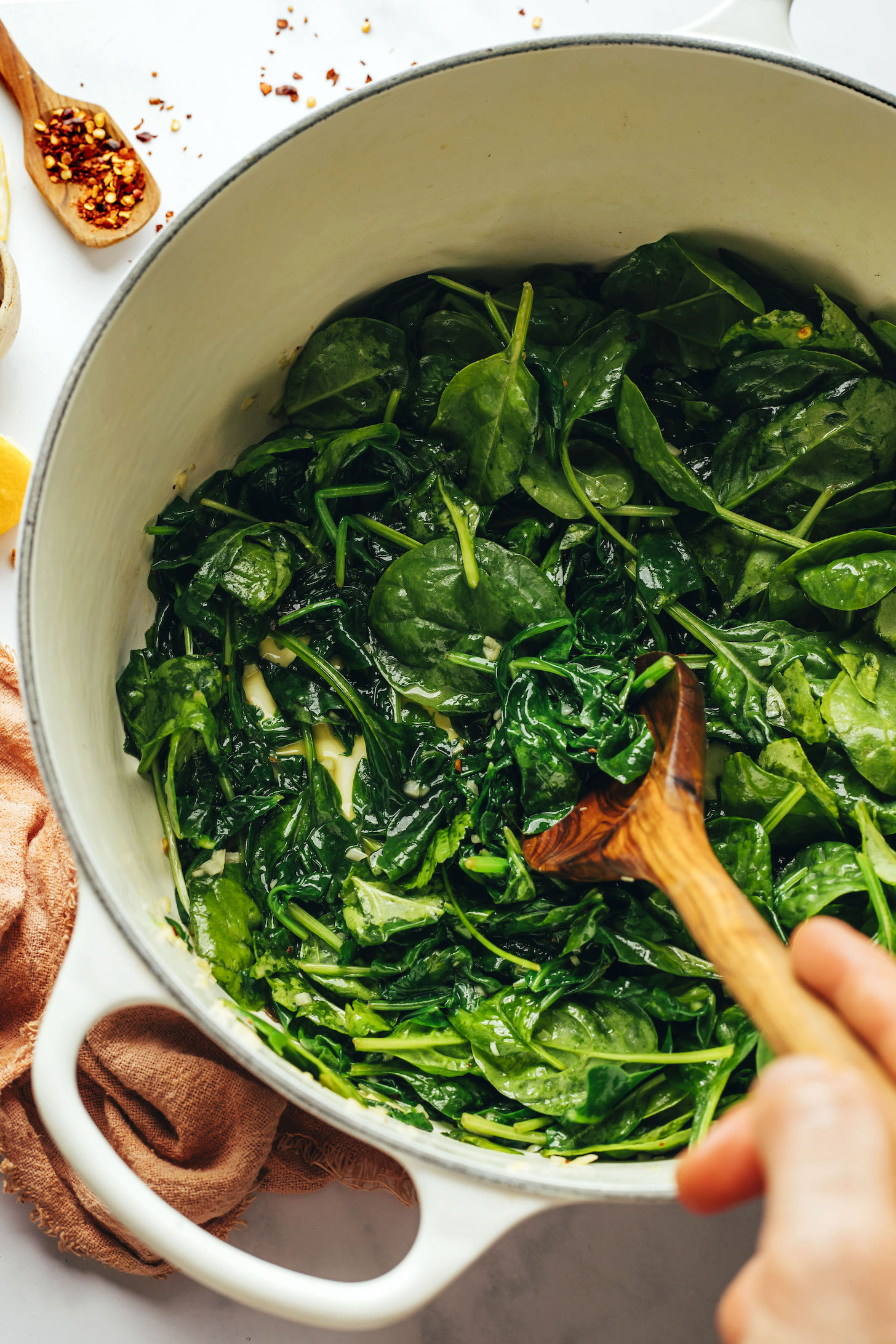 Sautéing spinach, garlic, and red pepper flakes
