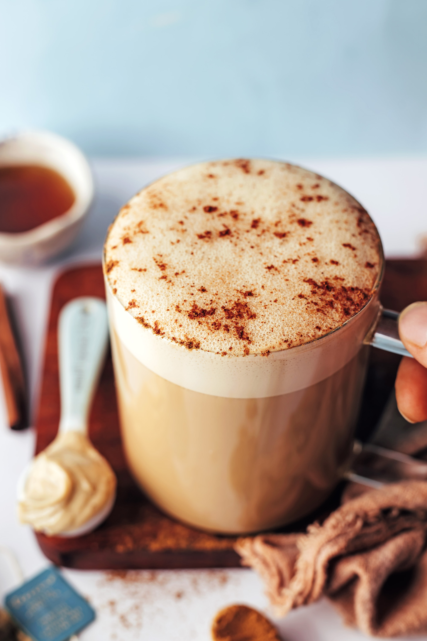 Cinnamon sprinkled over the frothy top of a cinnamon vanilla dandelion tea latte