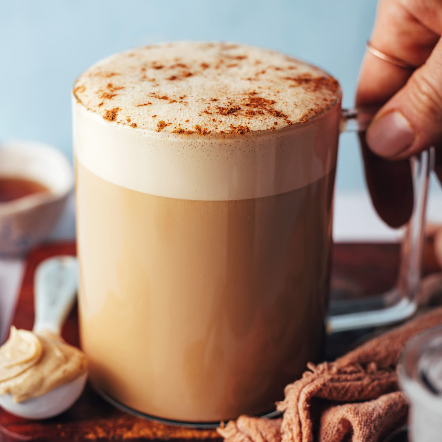 Holding the handle of a mug filled with our dandelion tea latte recipe