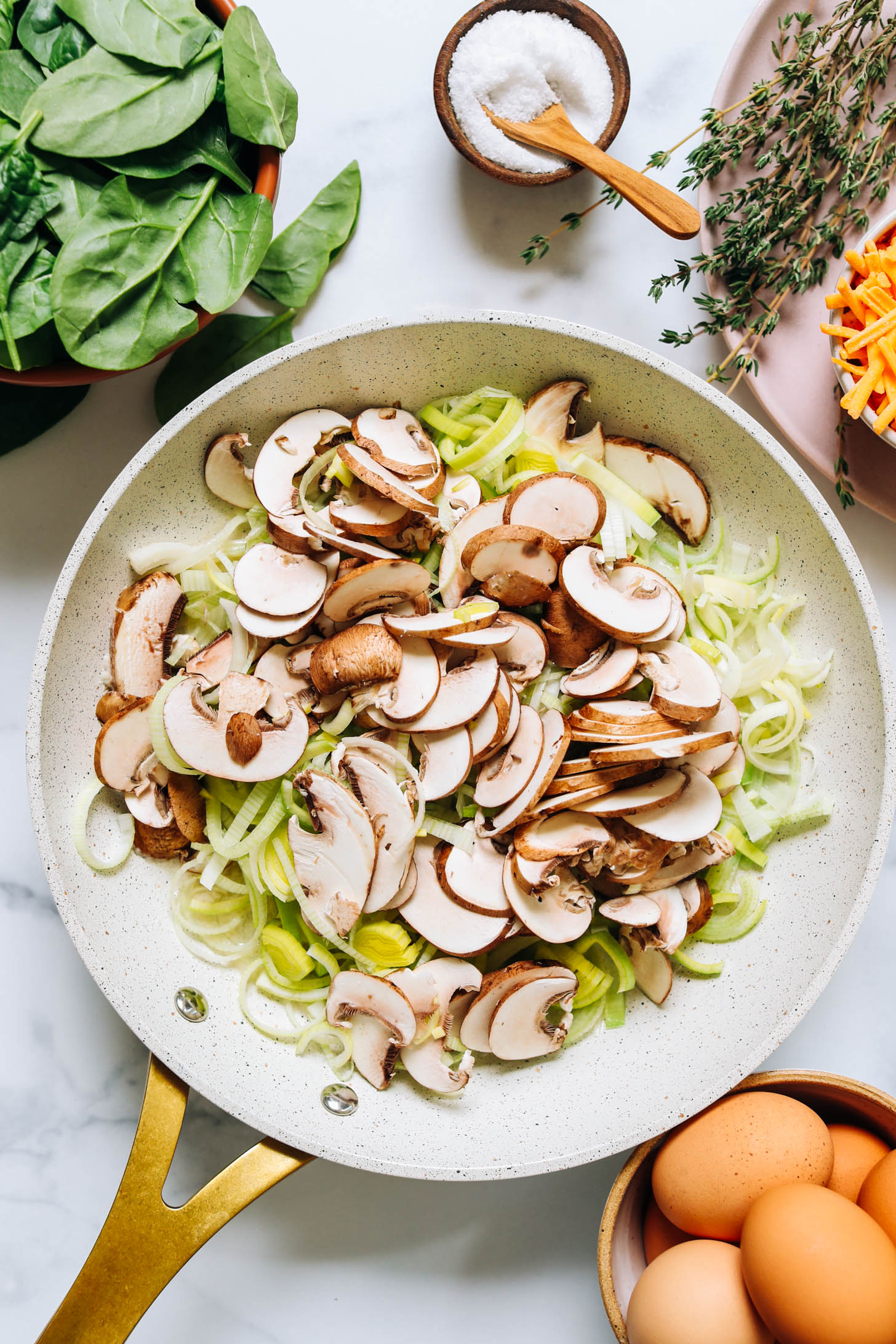 Sautéing mushrooms and leeks in a skillet