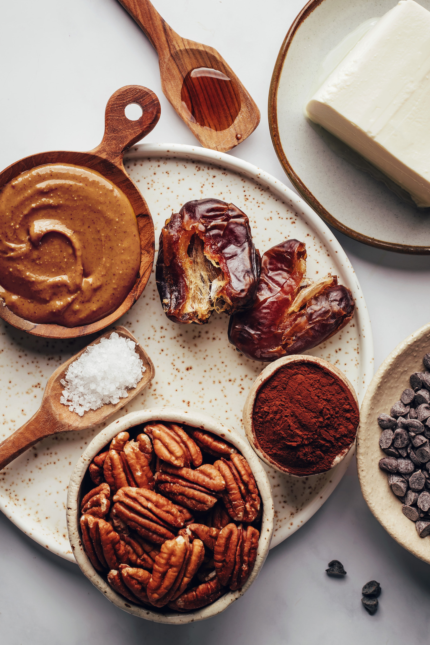 Dates, almond butter, salt, pecans, cocoa powder, chocolate chips, vegan butter, and vanilla