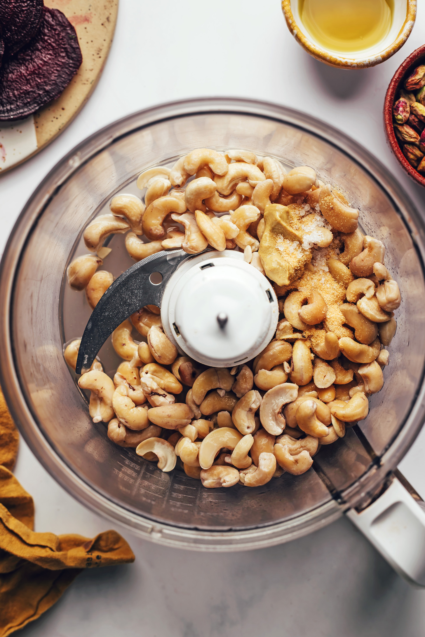 Cashews, salt, garlic powder, and Dijon mustard in a food processor