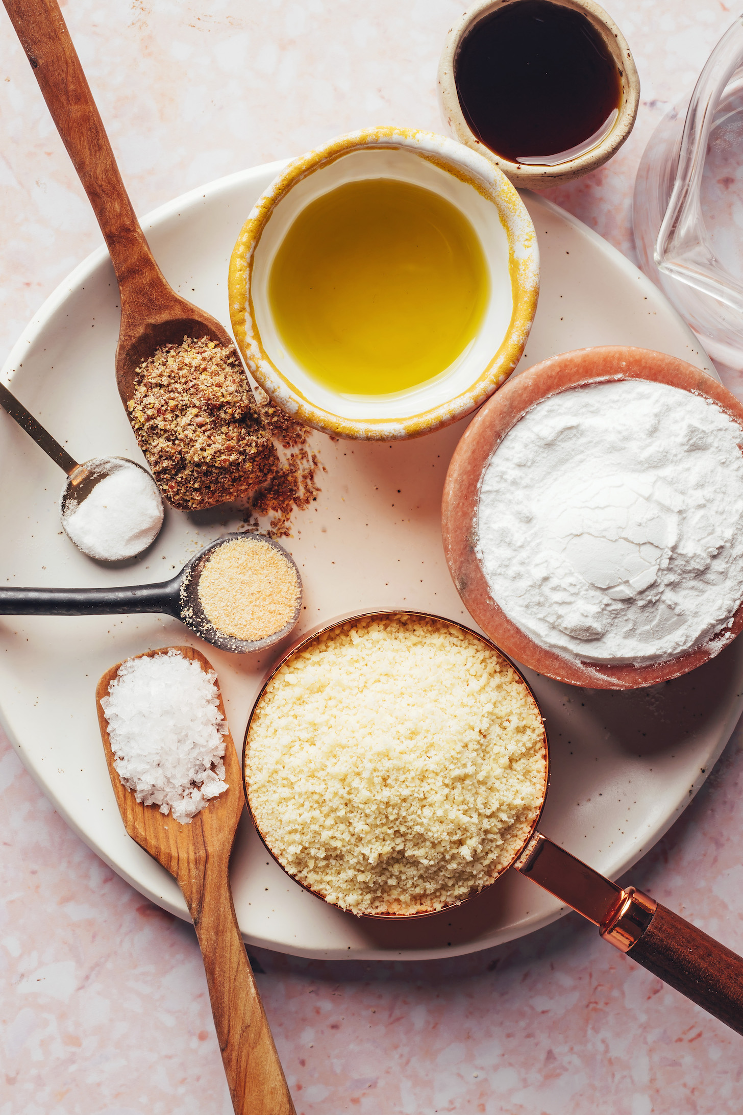 Olive oil, maple syrup, water, tapioca flour, almond flour, salt, garlic powder, baking soda, and flaxseed meal