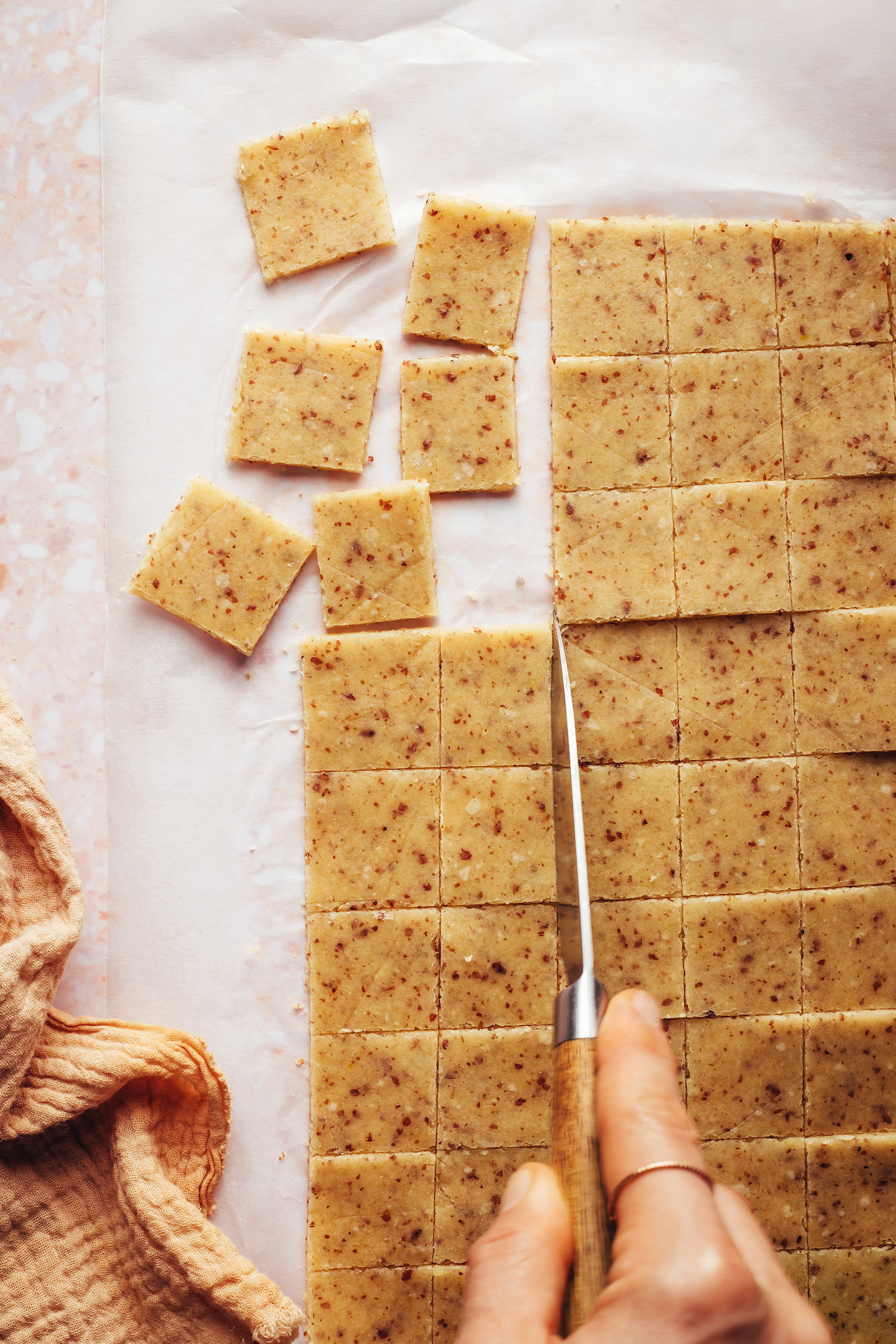Using a small knife to cut the dough into small squares