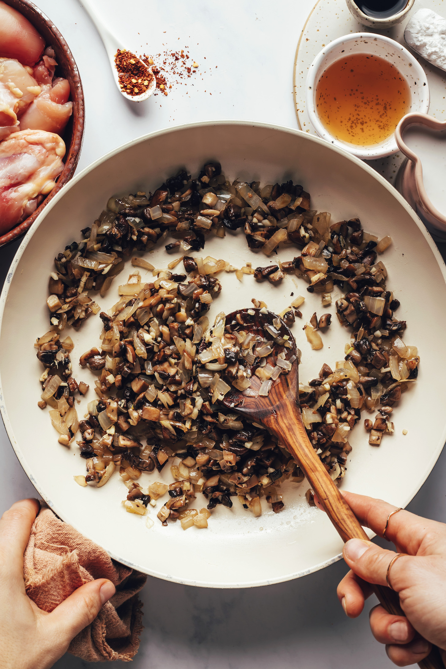 Sautéing mushrooms and onions in a large skillet
