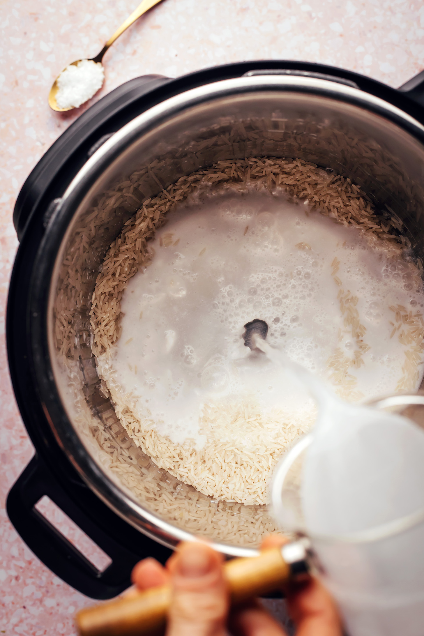 Pouring coconut water over rice