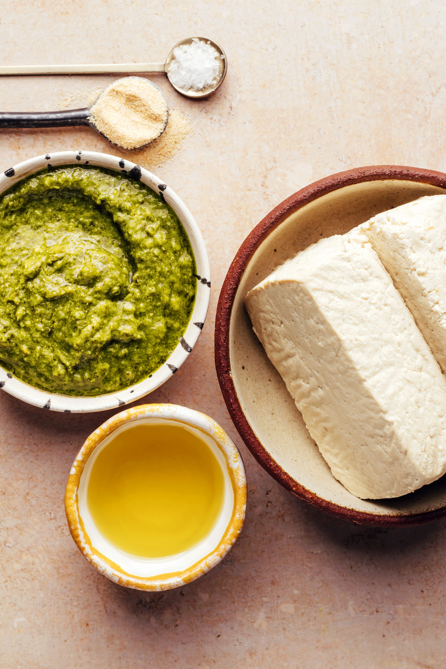 Salt, garlic powder, pesto, olive oil, and super firm tofu