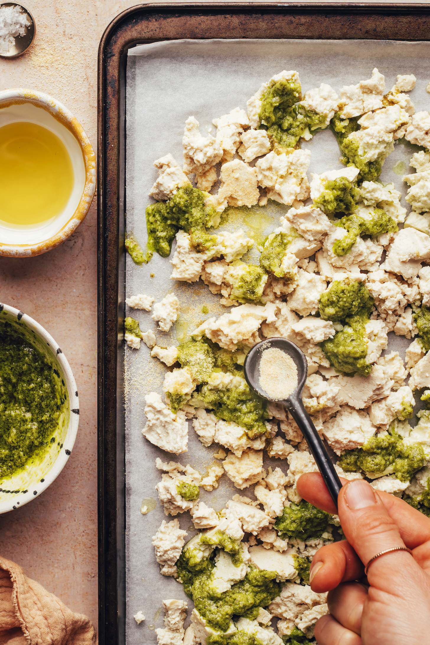 Sprinkling garlic powder over crumbled tofu