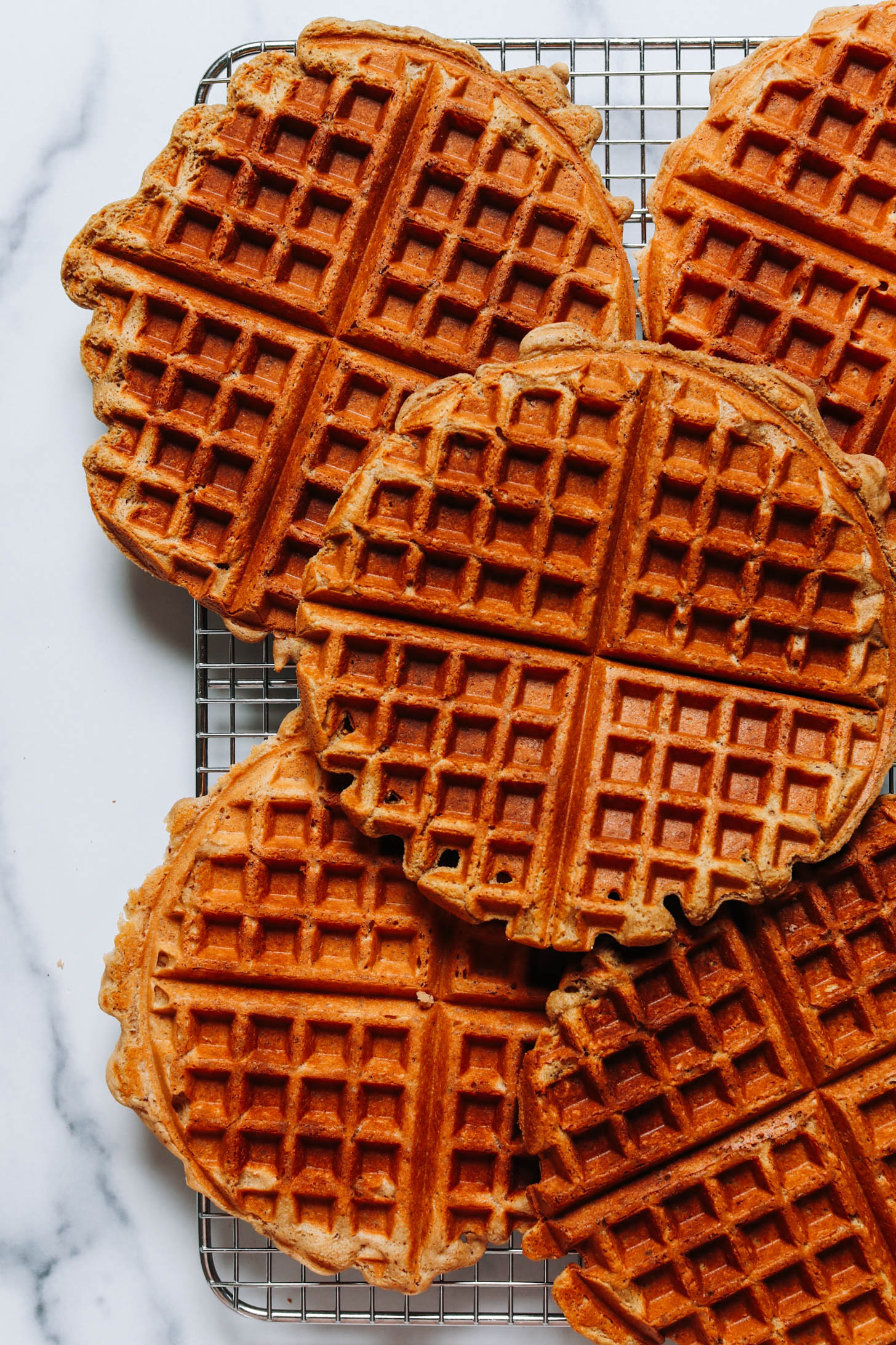 Crispy, golden brown vegan and gluten-free waffles on a cooling rack