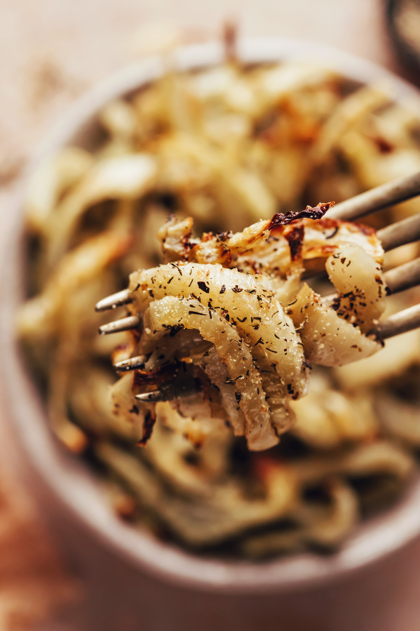 Bite of roasted sliced fennel on a fork