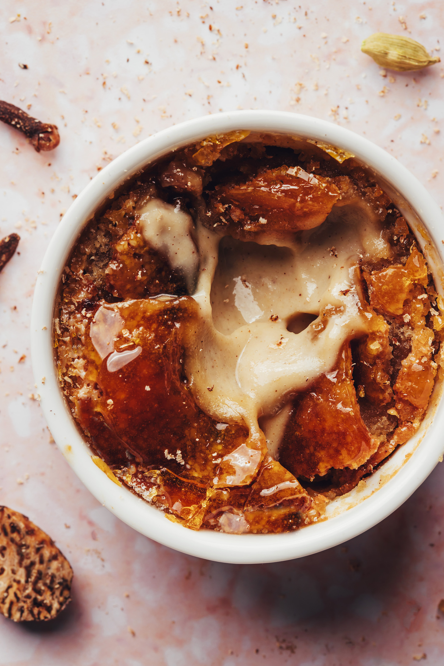 Cracked top on a ramekin of vegan creme brulee