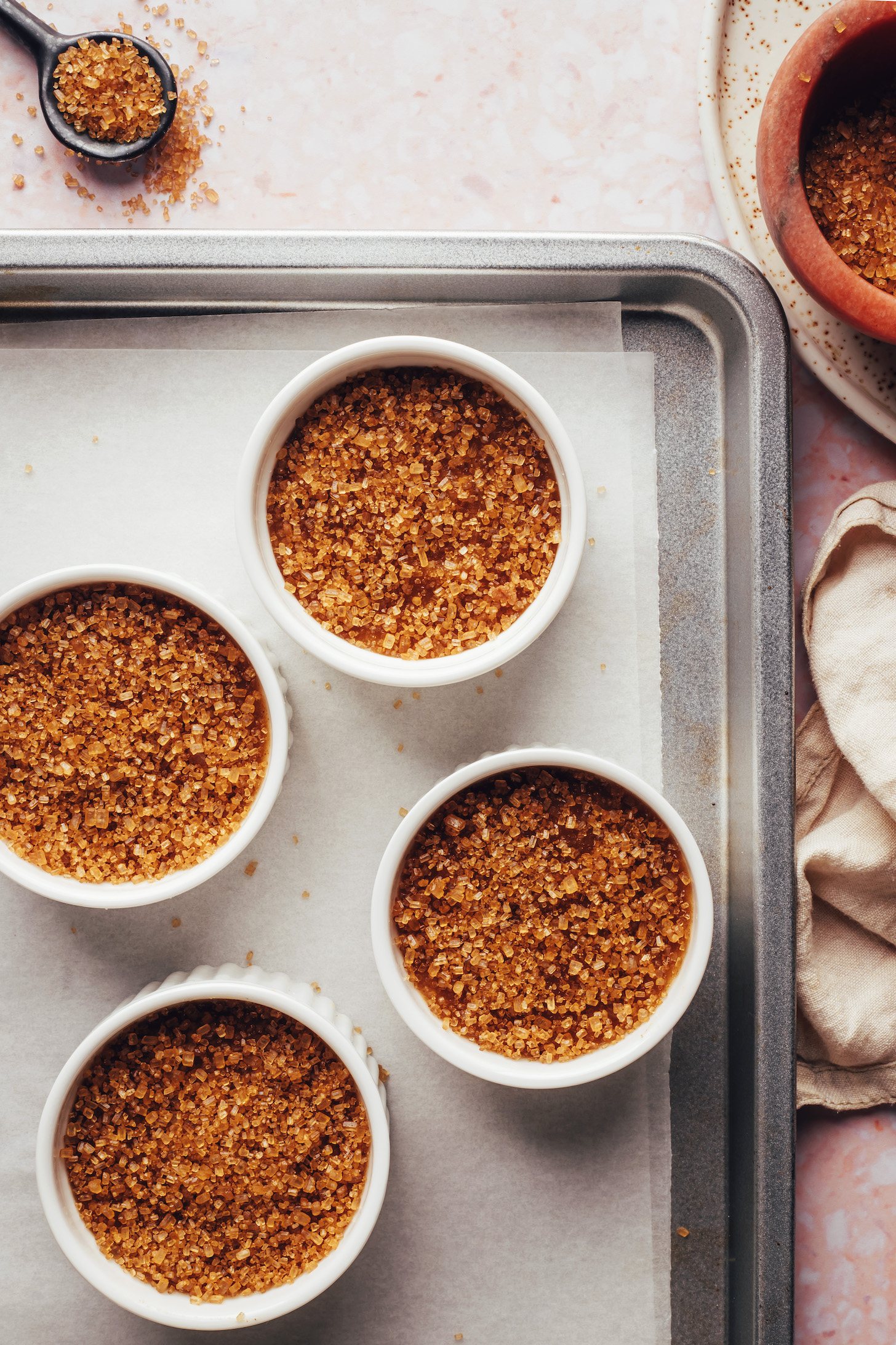 Ramekins with cane sugar sprinkled over a chai-spiced custard