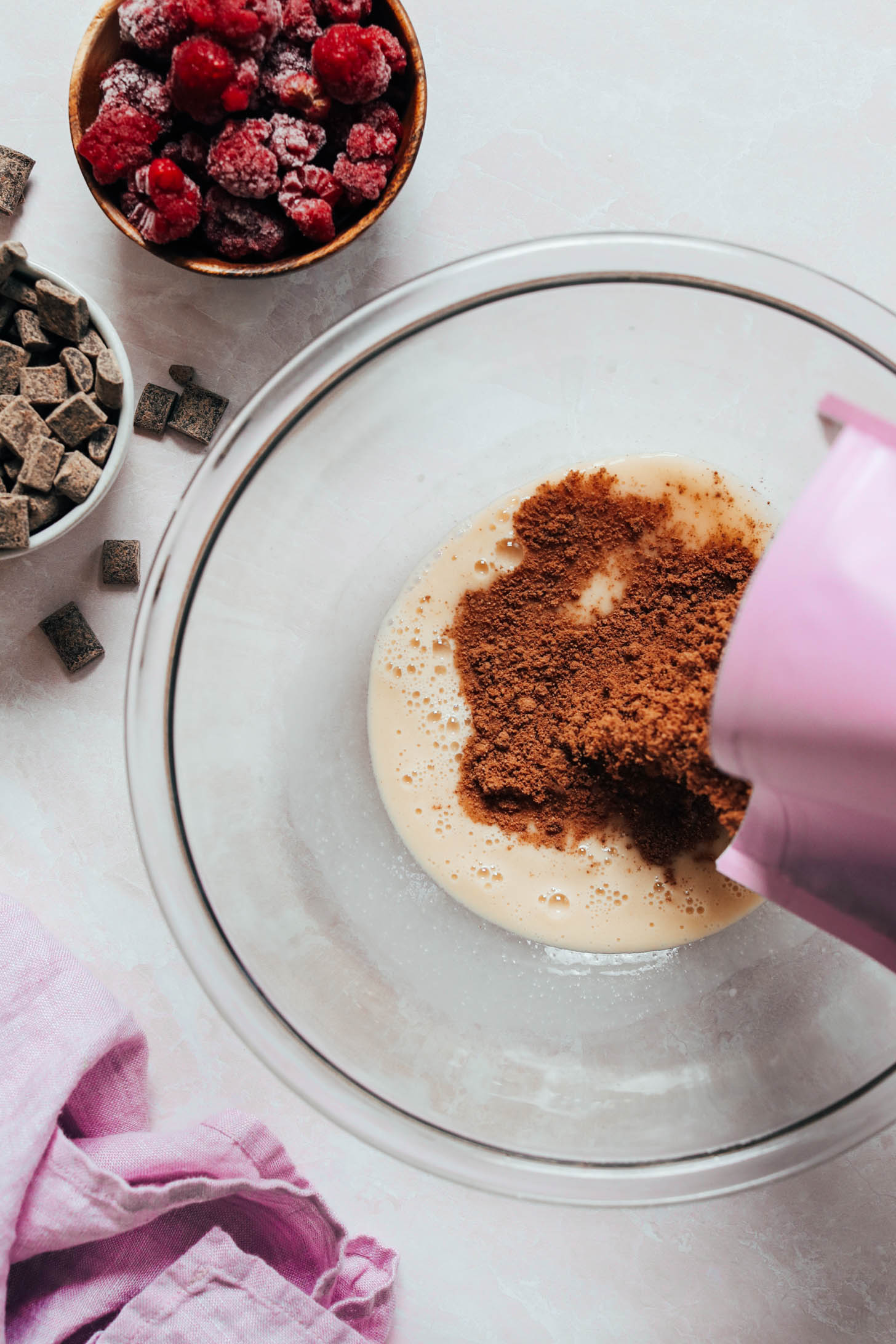 Pouring chocolate cake mix into the wet ingredients