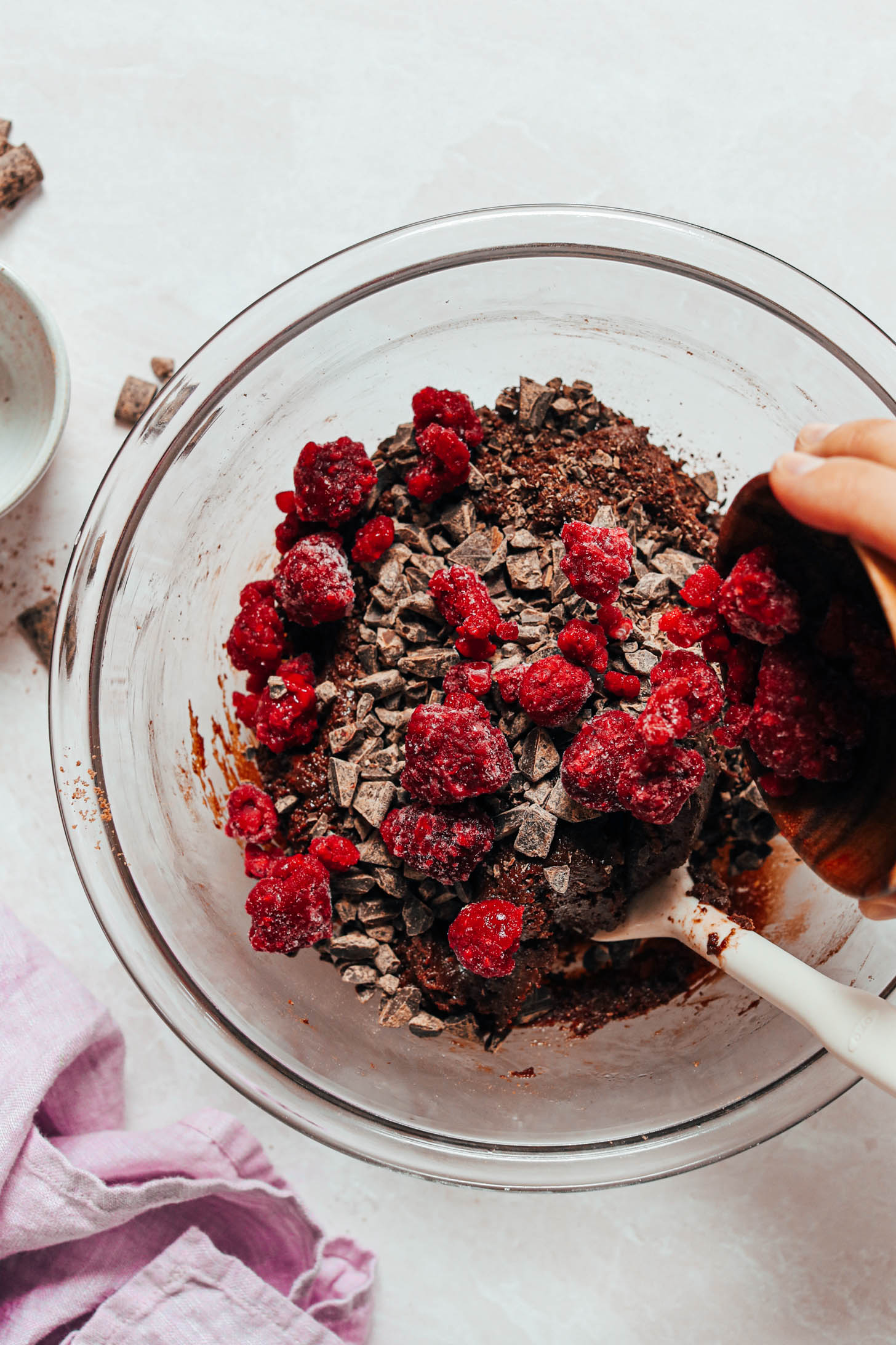Adding frozen raspberries and chopped chocolate to the cookie batter
