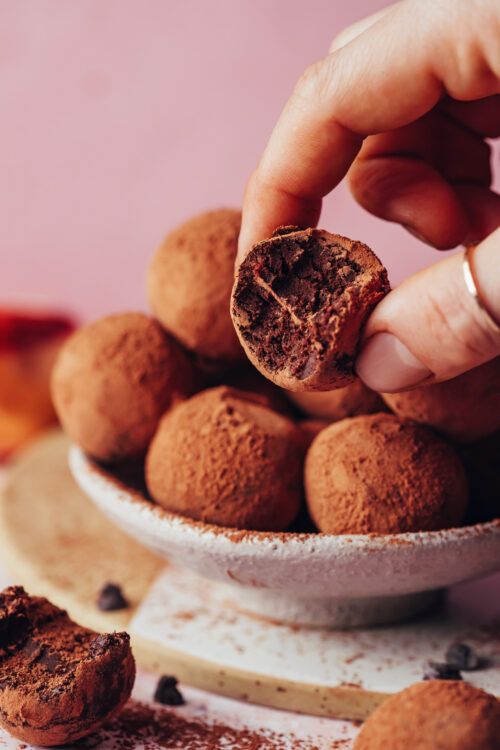 Holding a fudgy vegan chocolate truffle made with sweet potato