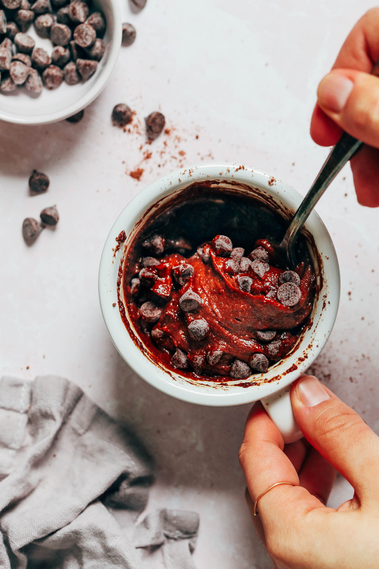 Stirring dairy-free chocolate chips into chocolate cake batter