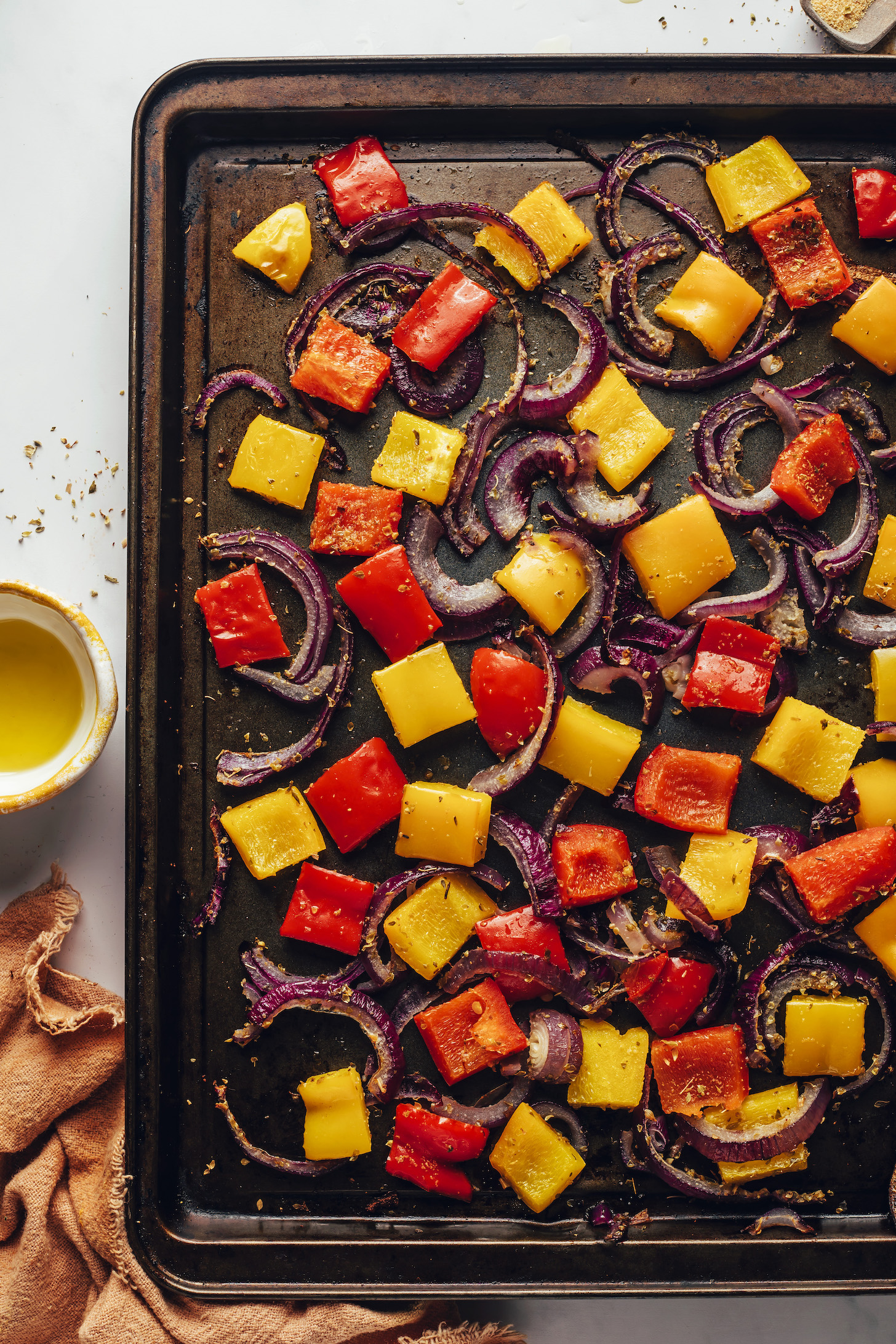 Roasted veggies with Italian spices on a baking sheet