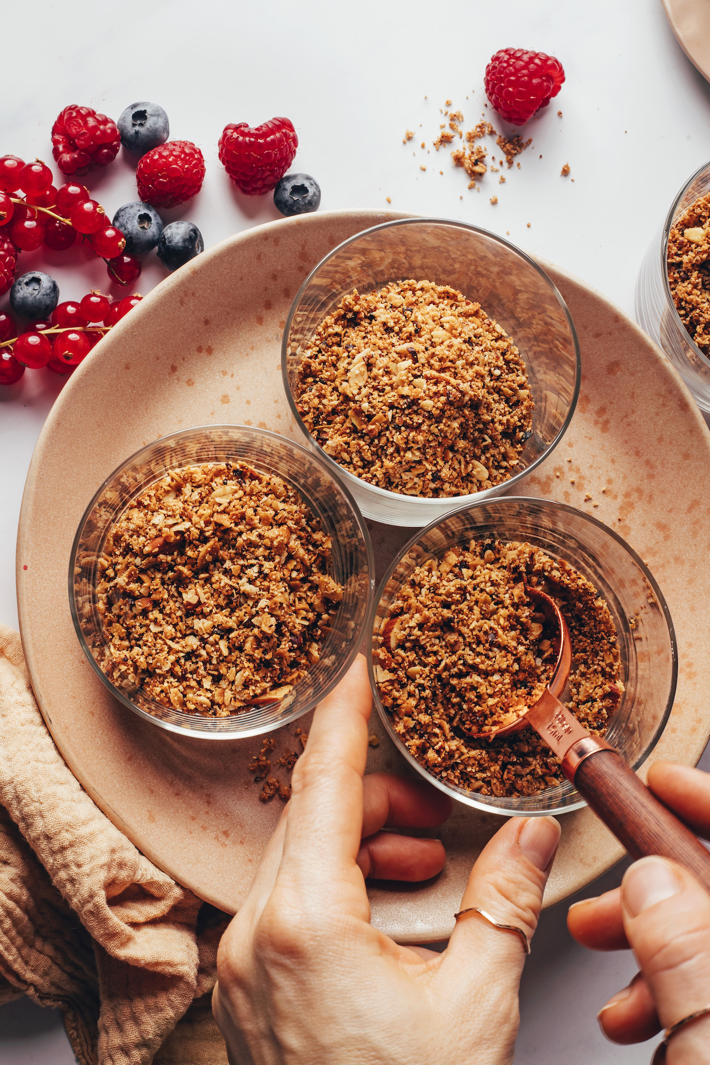 Adding blended granola to glasses