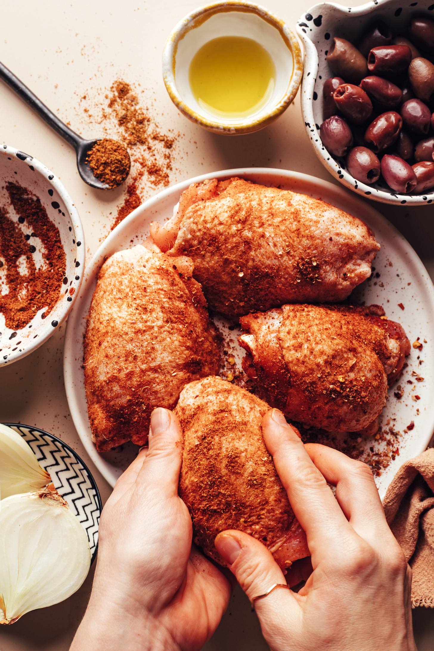 Rubbing smoky spices onto bone-in, skin-on chicken thighs