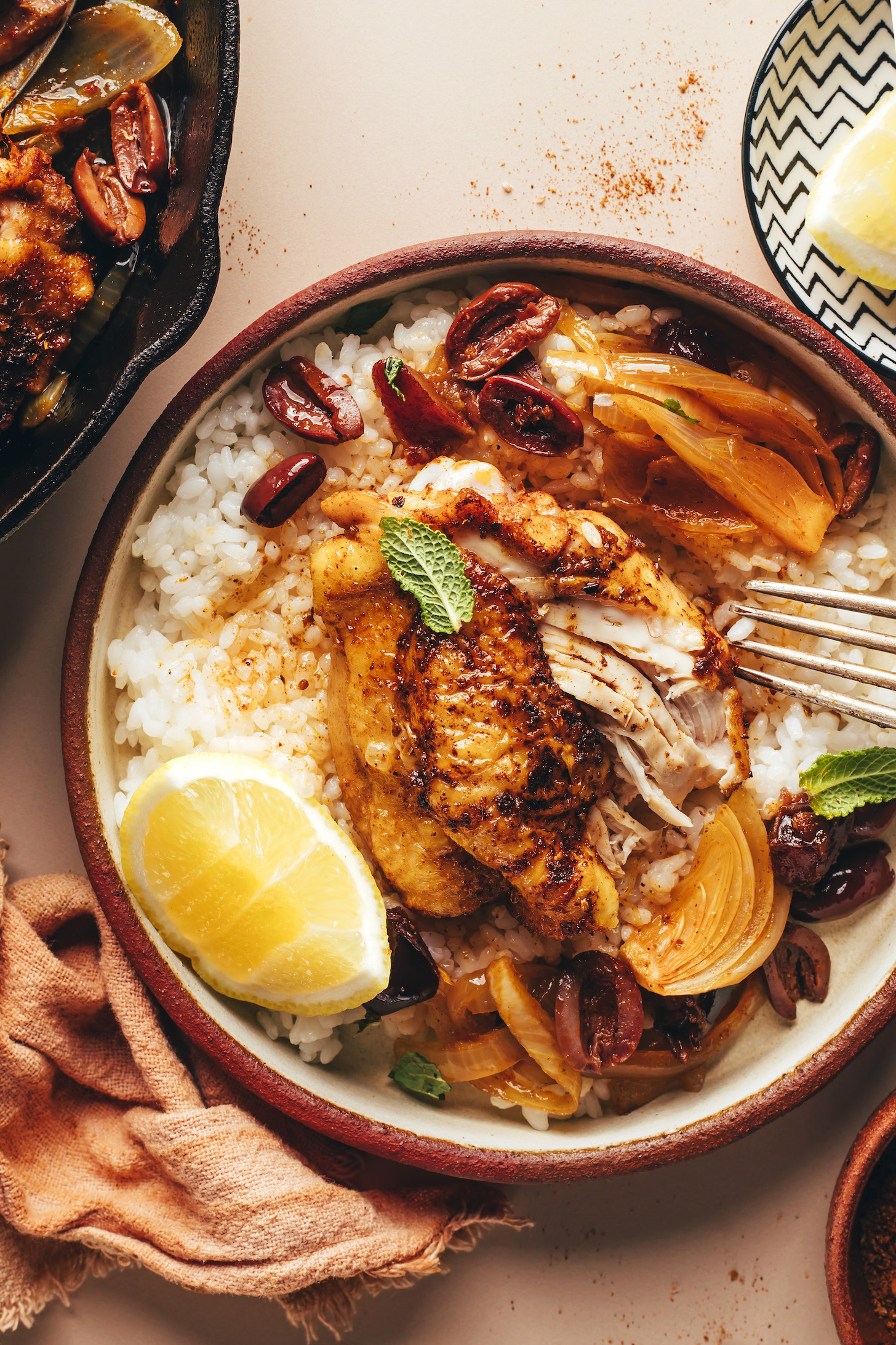 Bowl of rice topped with a chicken thigh with crispy skin and tender meat