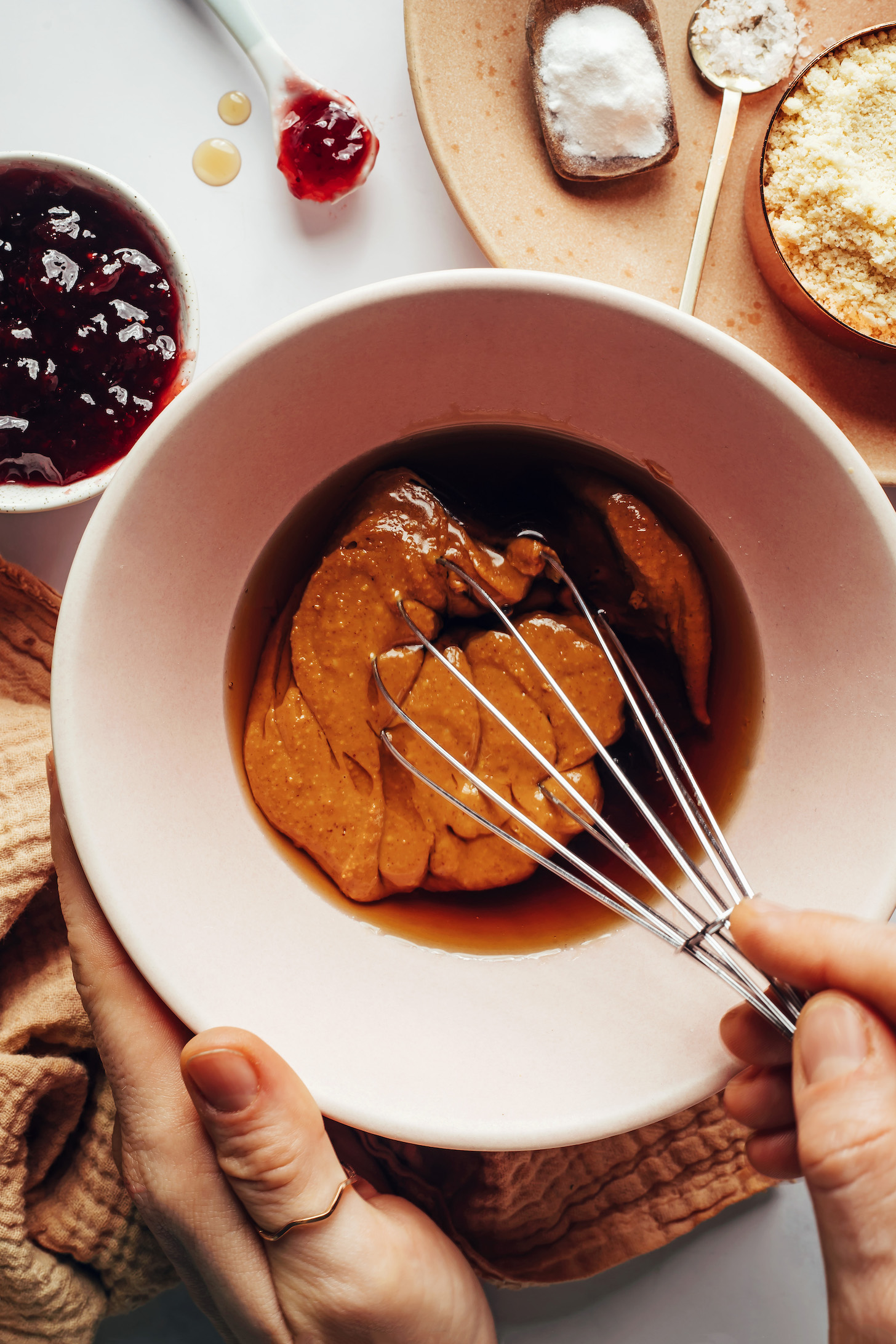 Whisking peanut butter, maple syrup, and vanilla in a bowl