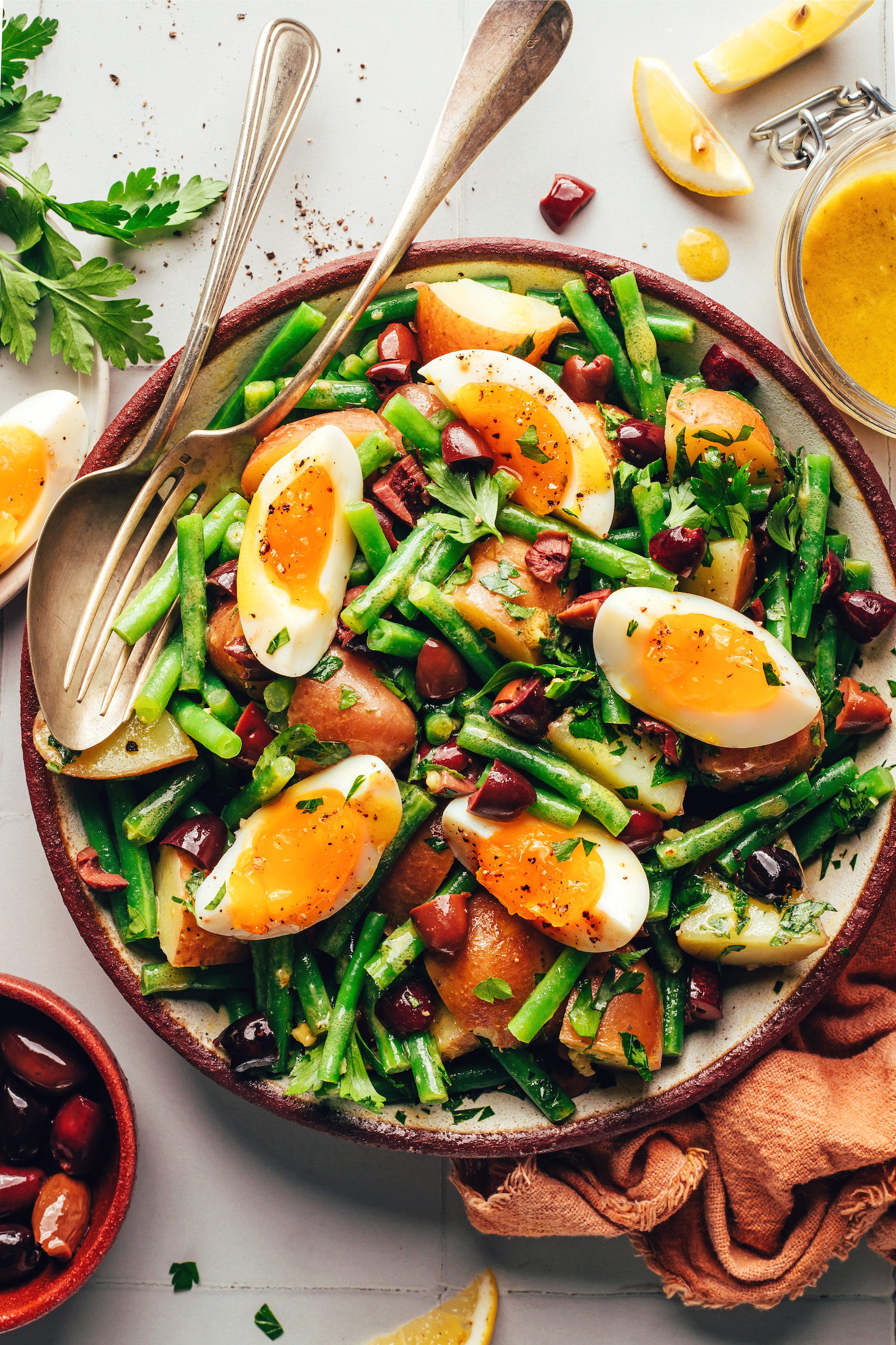 Jammy eggs atop a bowl of green bean potato salad