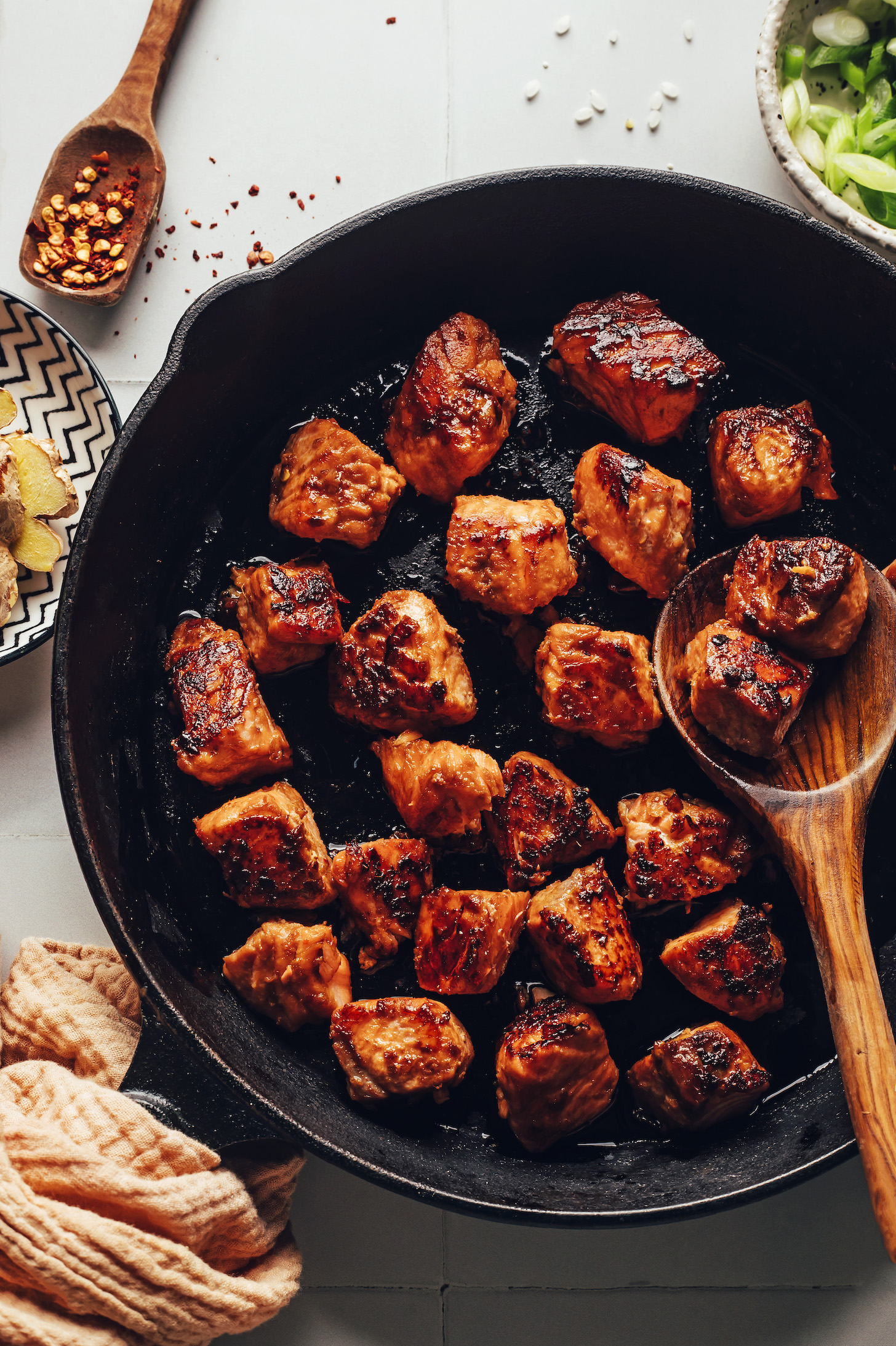 Perfectly browned cubes of salmon in a cast iron skillet