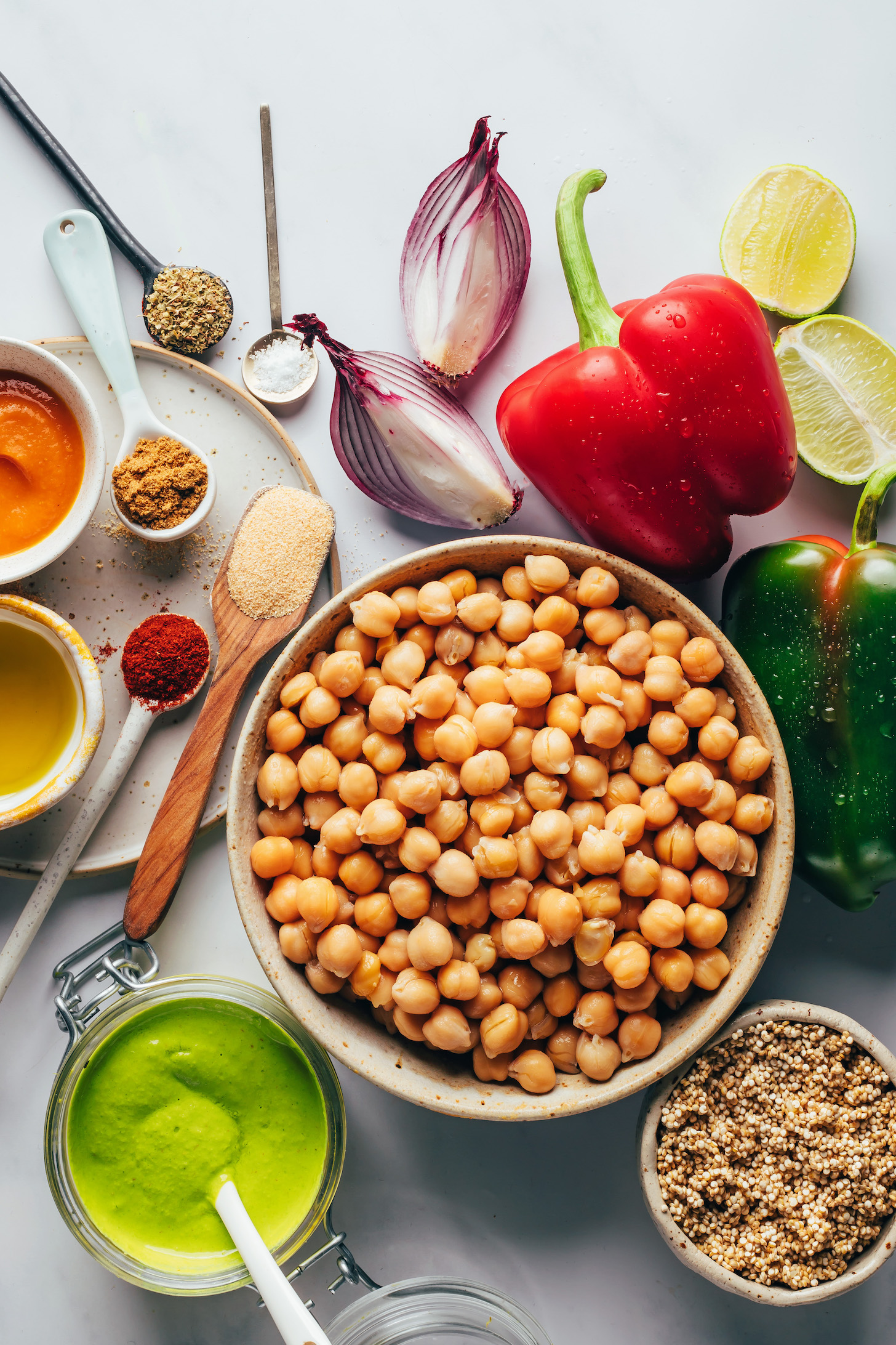 Chickpeas, peppers, limes, red onion, salt, spices, aji amarillo paste, aji verde sauce, and quinoa