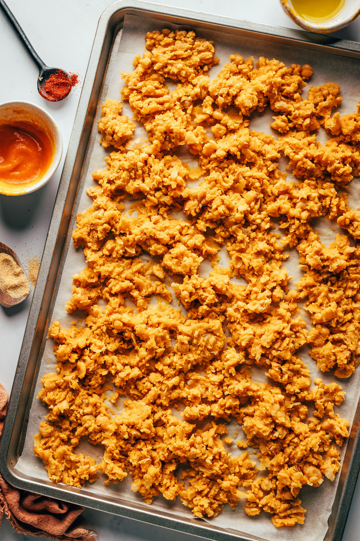 Spicy smashed chickpea taco "meat" on a baking sheet before baking