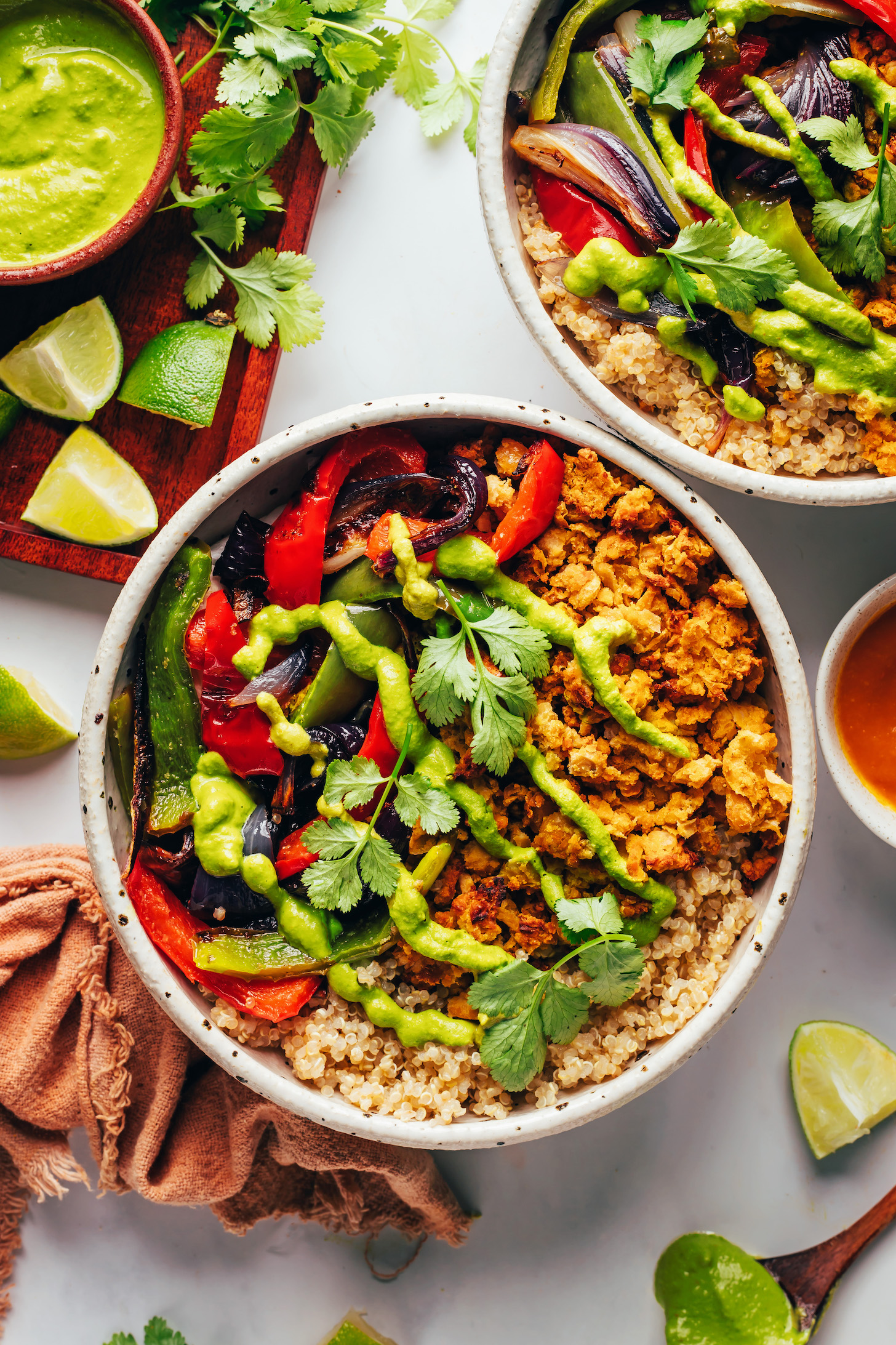 Quinoa, smashed chickpeas, and roasted peppers and onions topped with aji verde sauce and cilantro