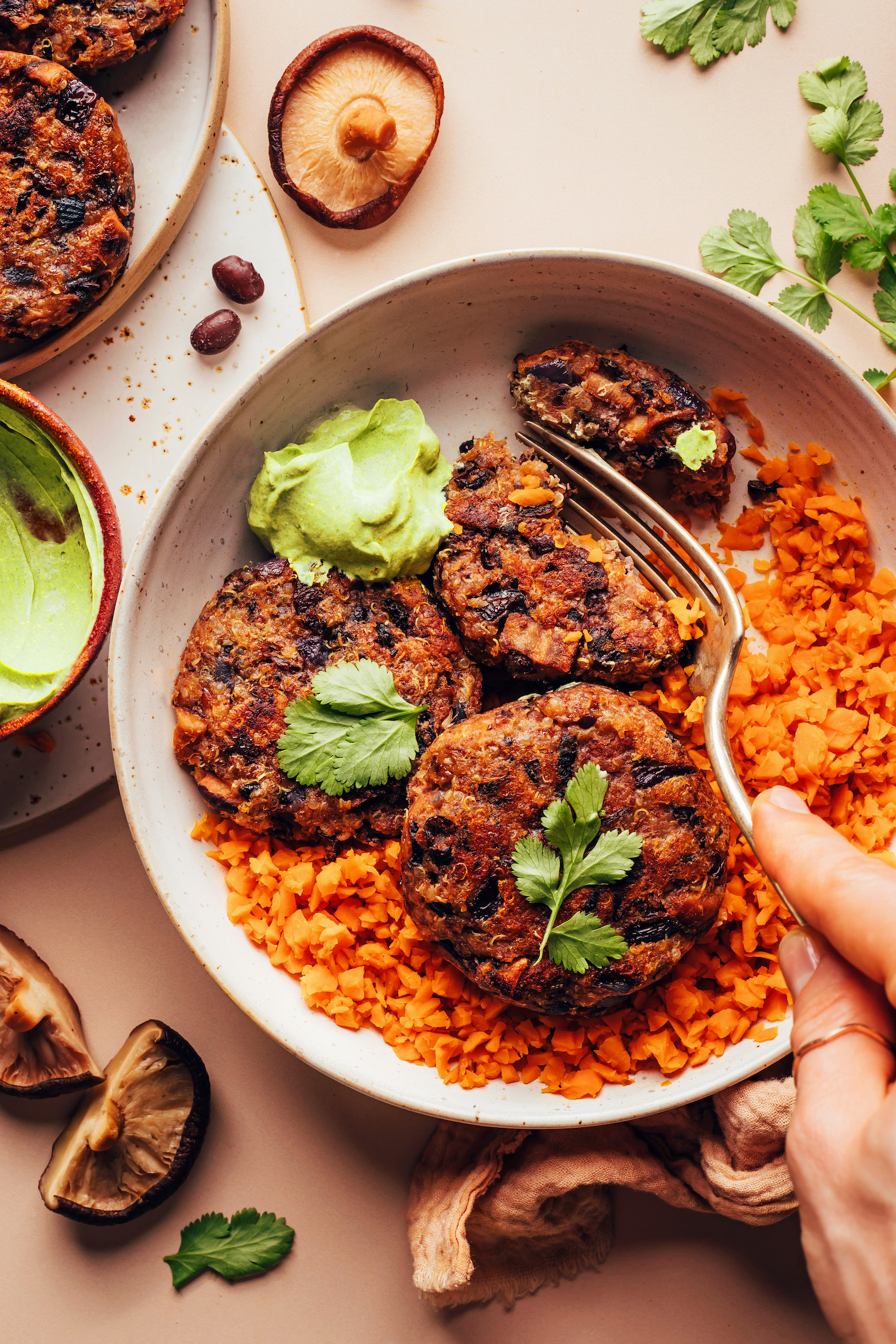 Fork cutting into a spicy mushroom black bean fritter