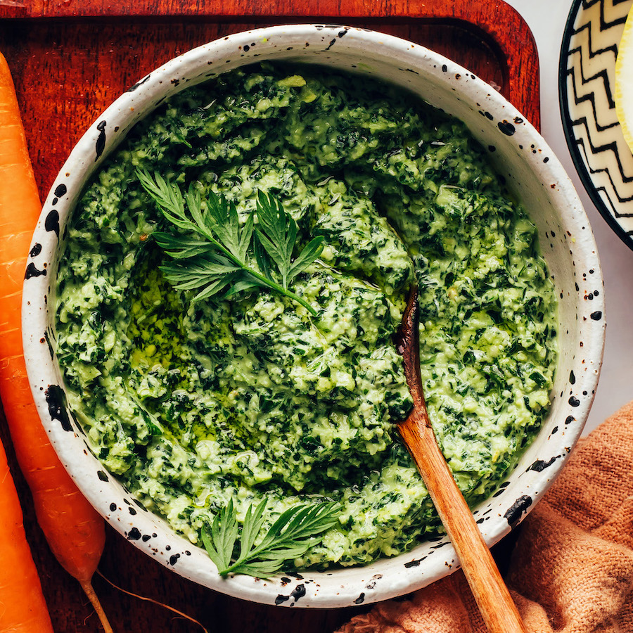 Overhead shot of a bowl of vegan carrot top pesto