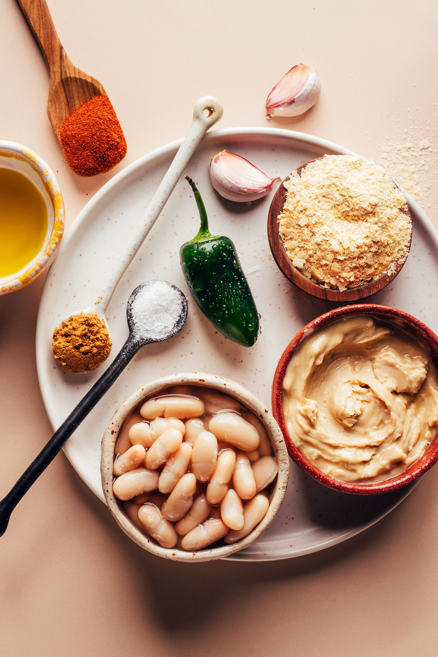 White beans, cashew butter, nutritional yeast, garlic, jalapeño, salt, cumin, olive oil, and smoked paprika