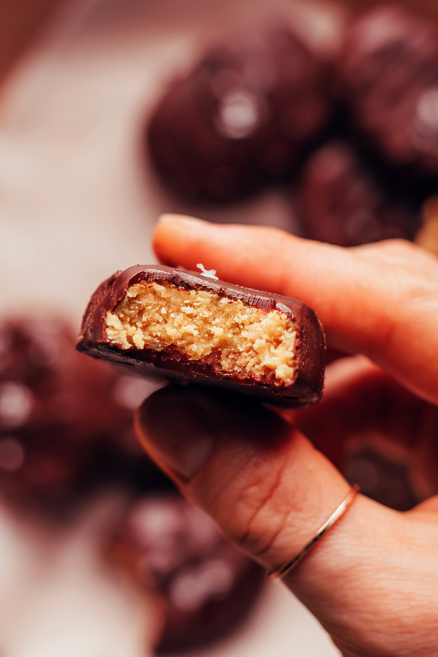 Holding up a peanut butter egg to show the inner texture