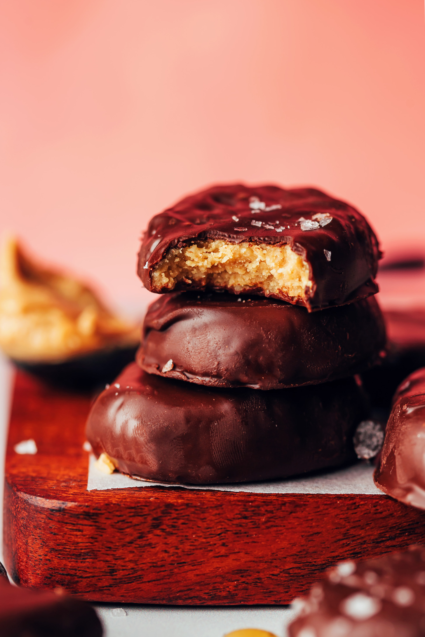 Stack of three homemade vegan peanut butter eggs with the top one partially eaten