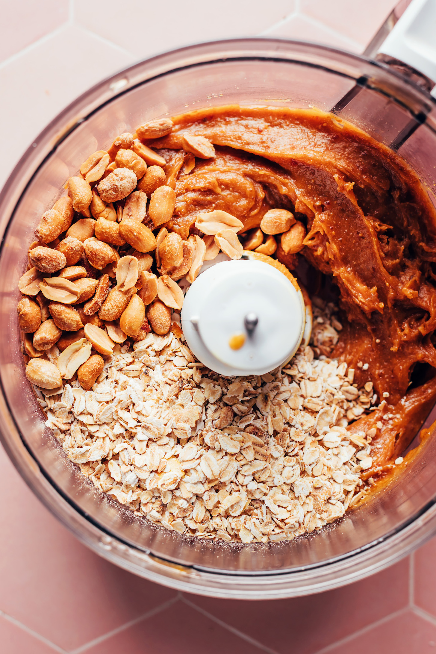 Peanuts and oats with peanut butter date paste in a food processor