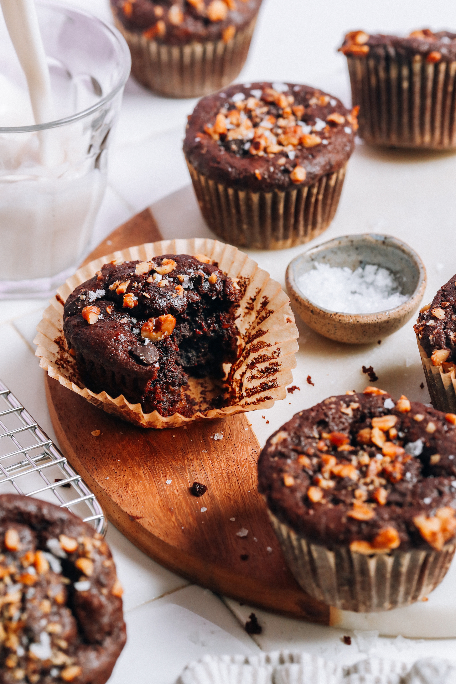 Glass of dairy-free milk next to vegan gluten-free banana chocolate chip nut muffins
