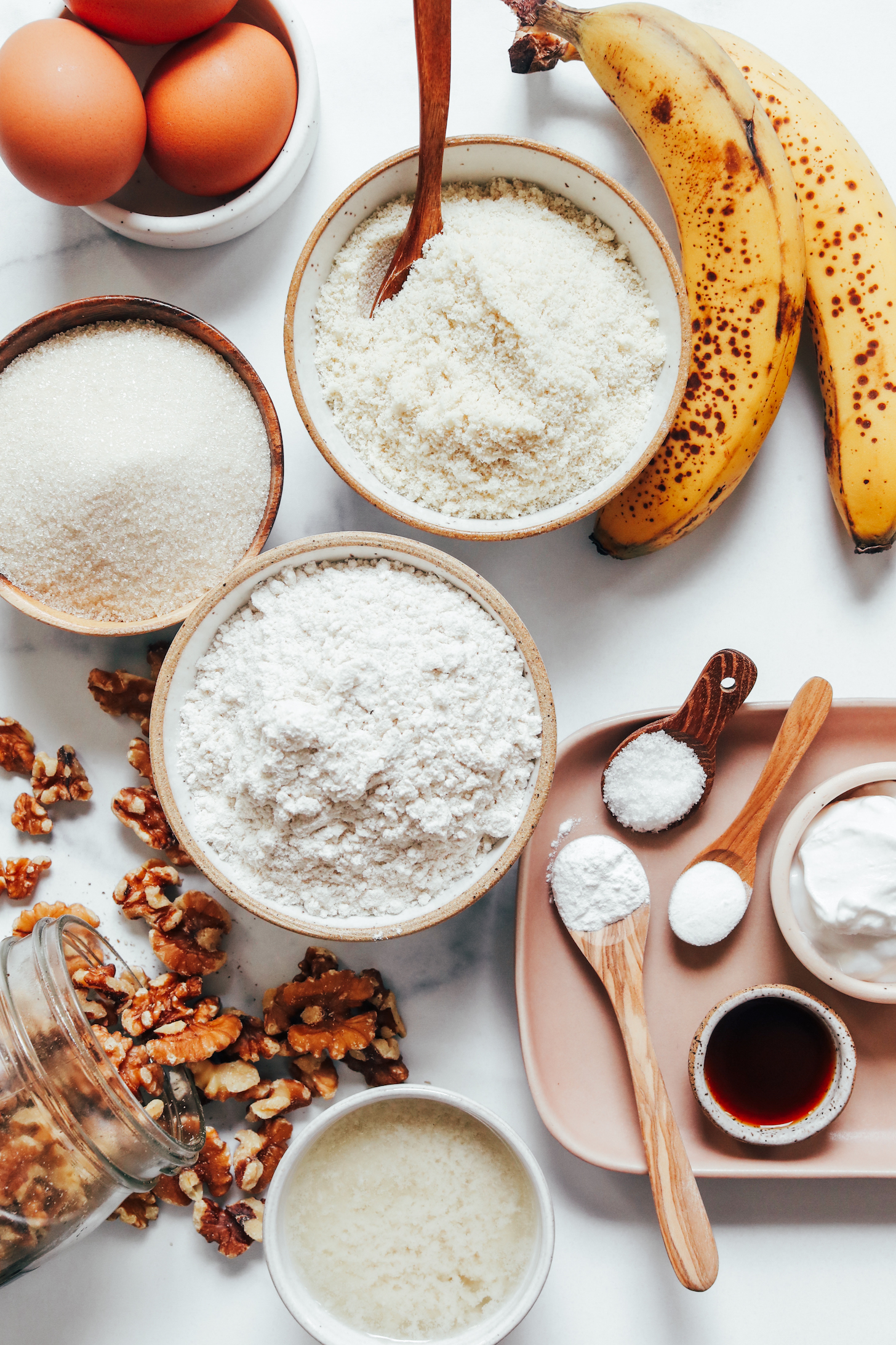 Eggs, bananas, almond flour, gluten-free flour blend, cane sugar, walnuts, dairy-free butter, baking soda, baking powder, vanilla, salt, and coconut yogurt