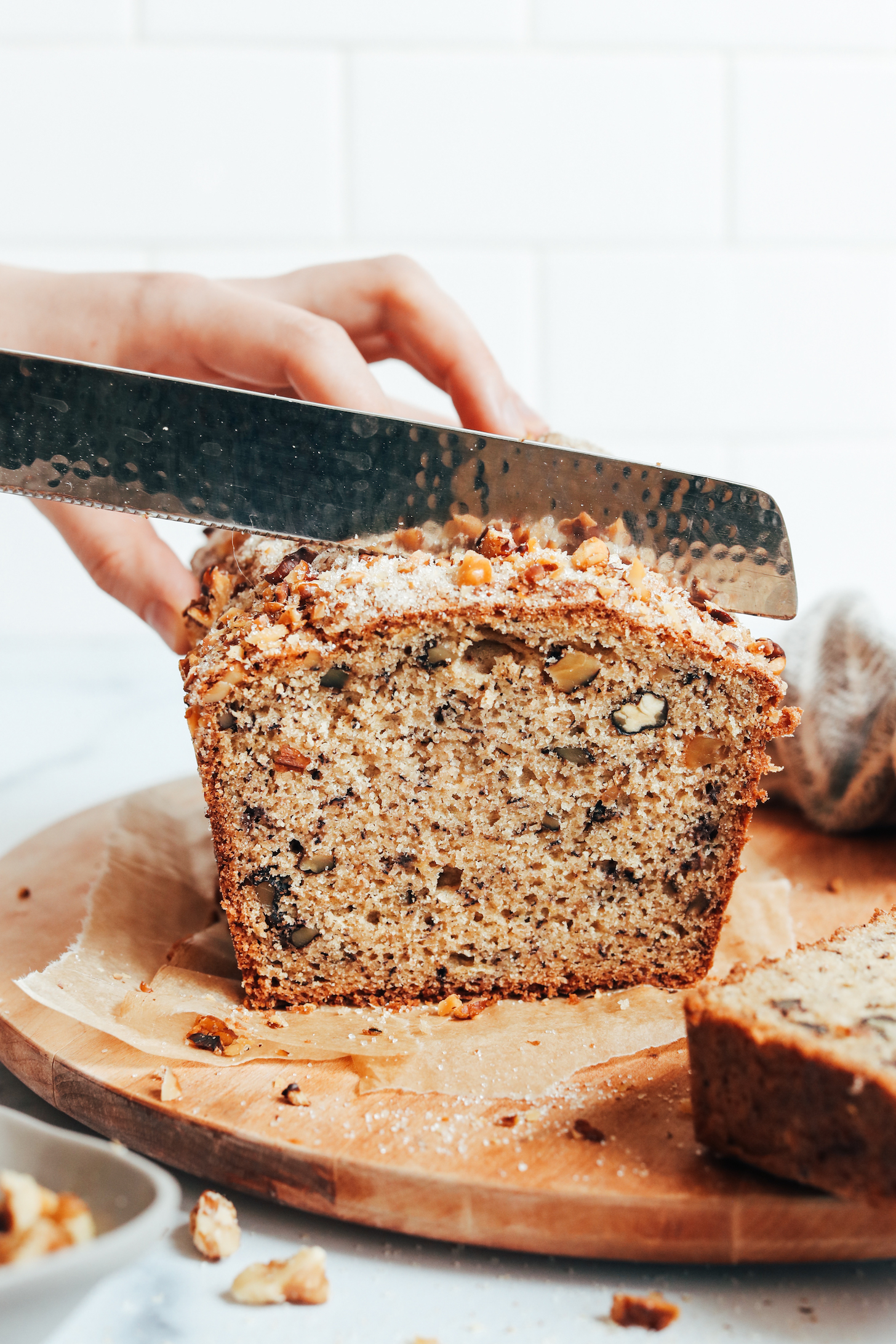 Slicing into a loaf of gluten-free dairy-free banana bread
