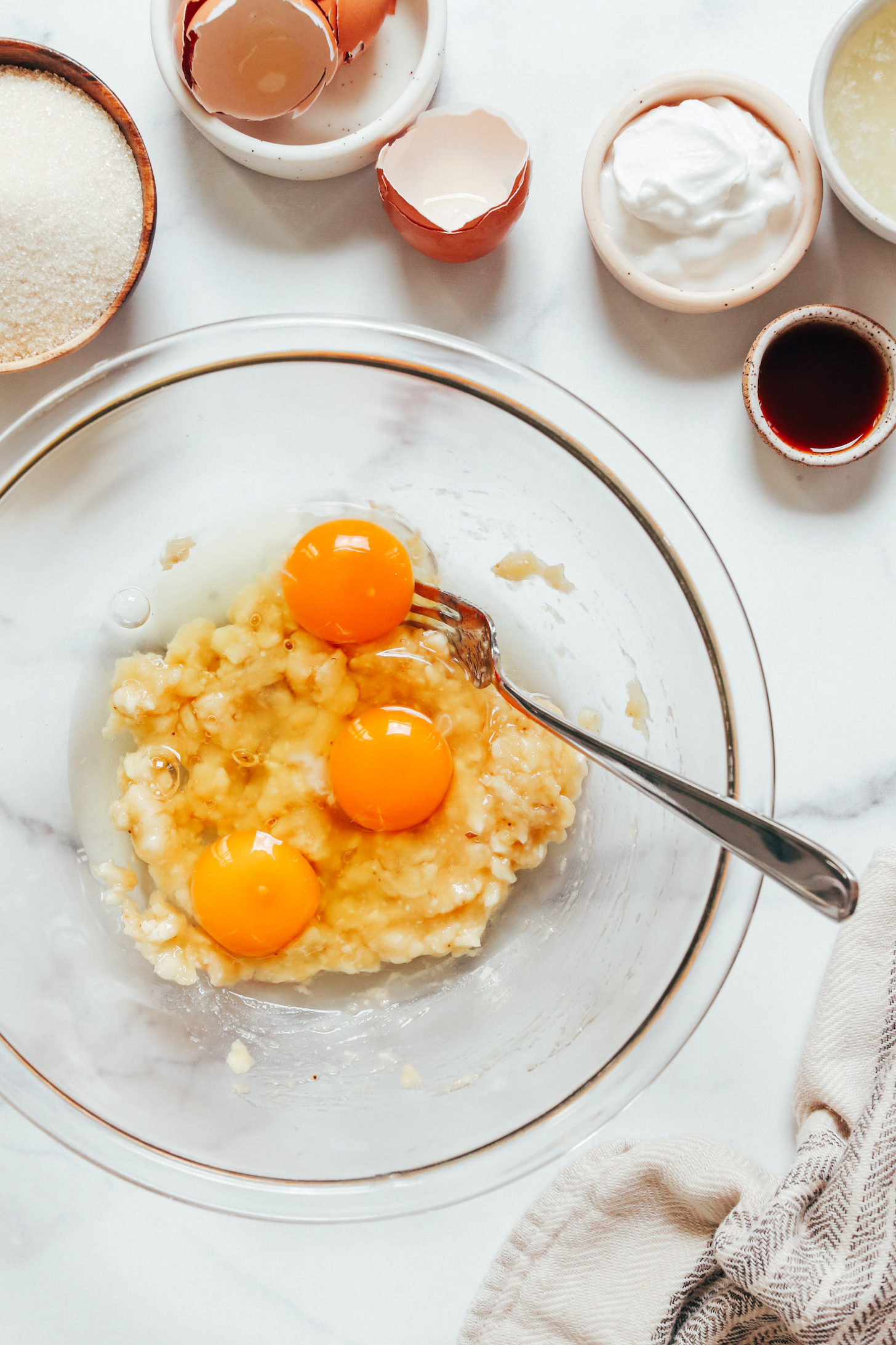Mashed banana and eggs in a bowl