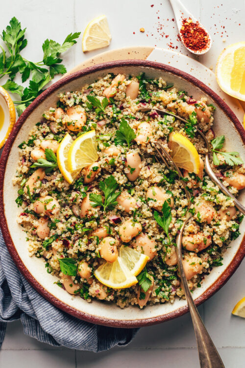 Spoon in a bowl of white bean quinoa salad