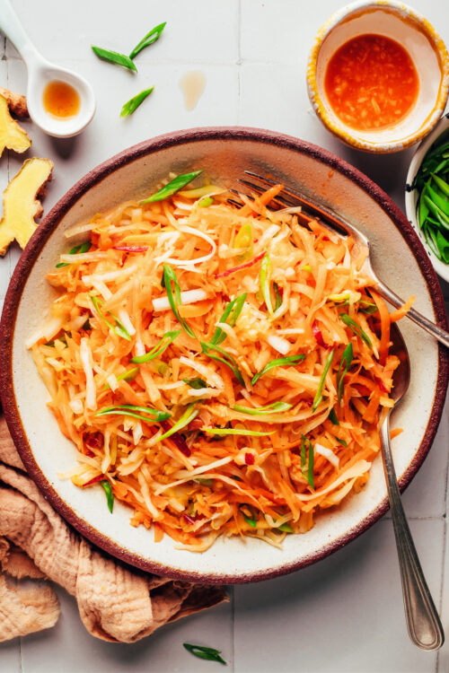 Overhead shot of a bowl of cabbage apple slaw tossed with a Korean-inspired dressing