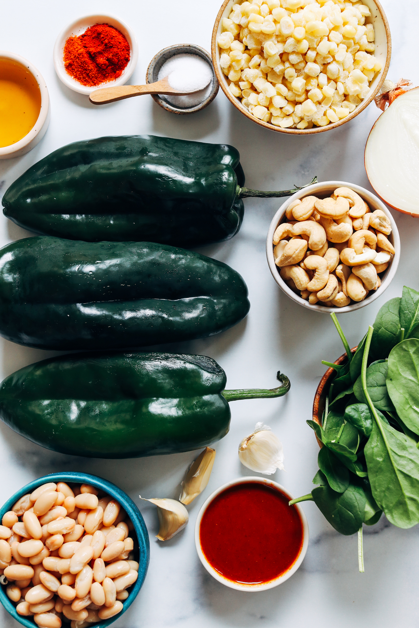 White beans, pobalno peppers, oil, spices, salt, corn, onion, cashews, spinach, garlic, and enchilada sauce